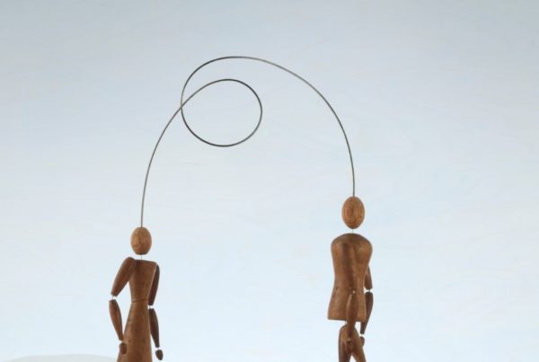 Human figurines connected with wire