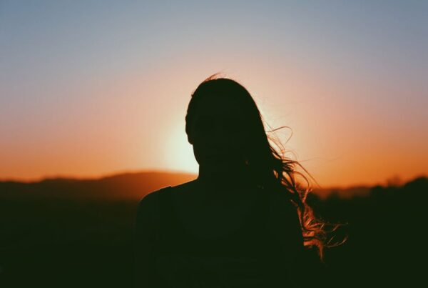 Woman's shadow against sunset