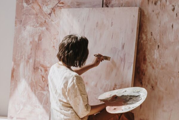 Woman accessing her creative self by painting.